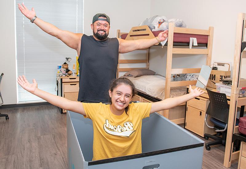 Student moving in to dorm with help of parent.